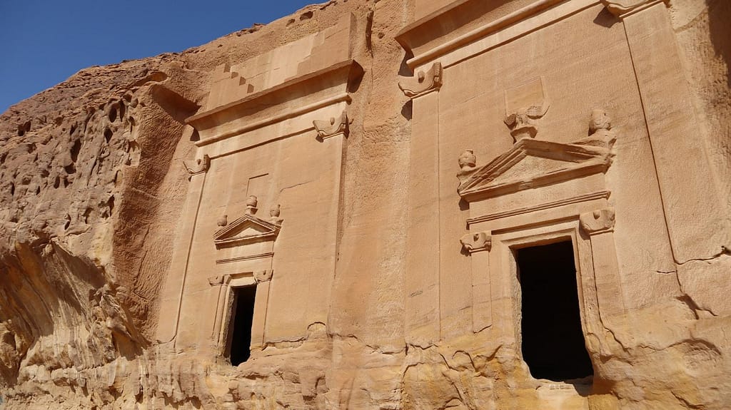 a building made of rock with two small windows