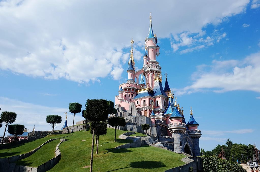 white and blue castle under white clouds and blue sky during daytime