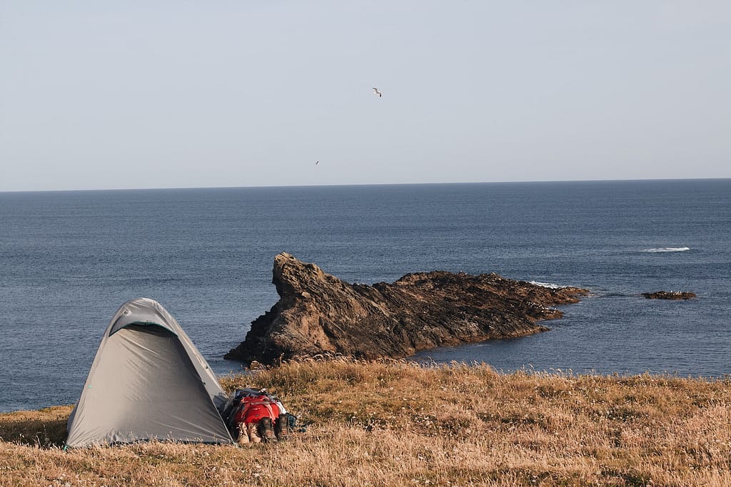 a tent next to a rock