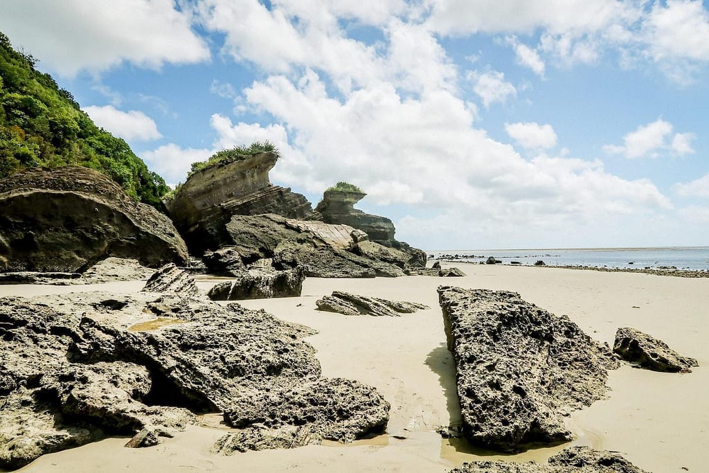 gray rock formation on sea shore during daytime