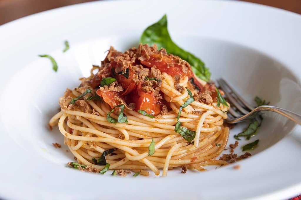 a plate of spaghetti with meat and tomato sauce