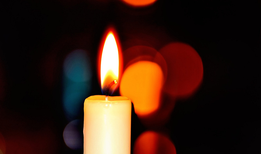 white candle in bokeh photography