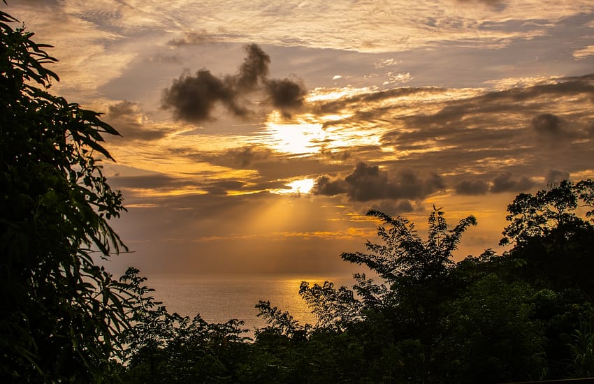 the sun is shining through the clouds over the ocean