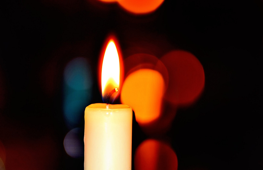 white candle in bokeh photography